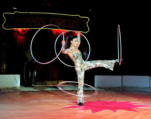 lady with a hula hoop spinning around each limb