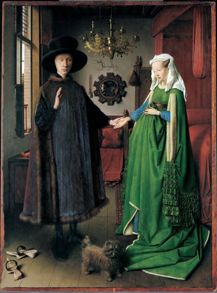 Man and woman stand in medieval Dutch house with fine clothes posing for portrait