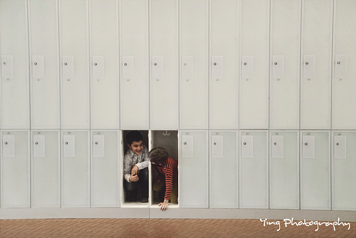 two kids hiding inside a pair of lockers