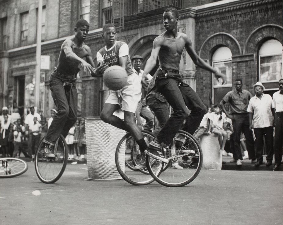 boys playing unicycle basketball