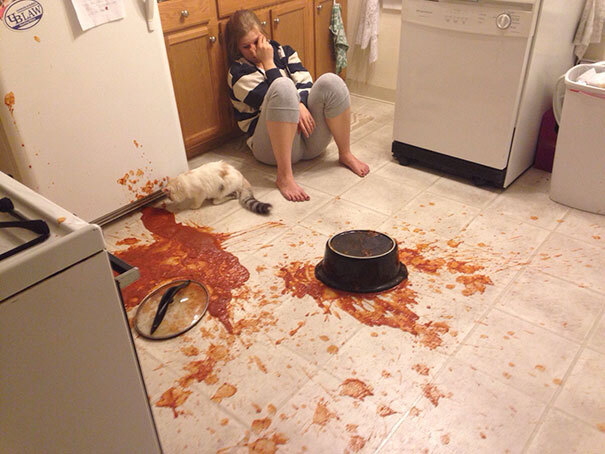 A woman sits upset after her meal has been dropped.
