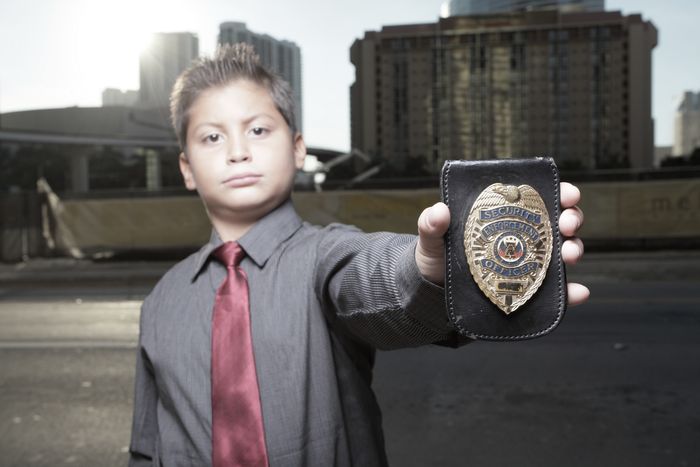 Child detective showing his badge