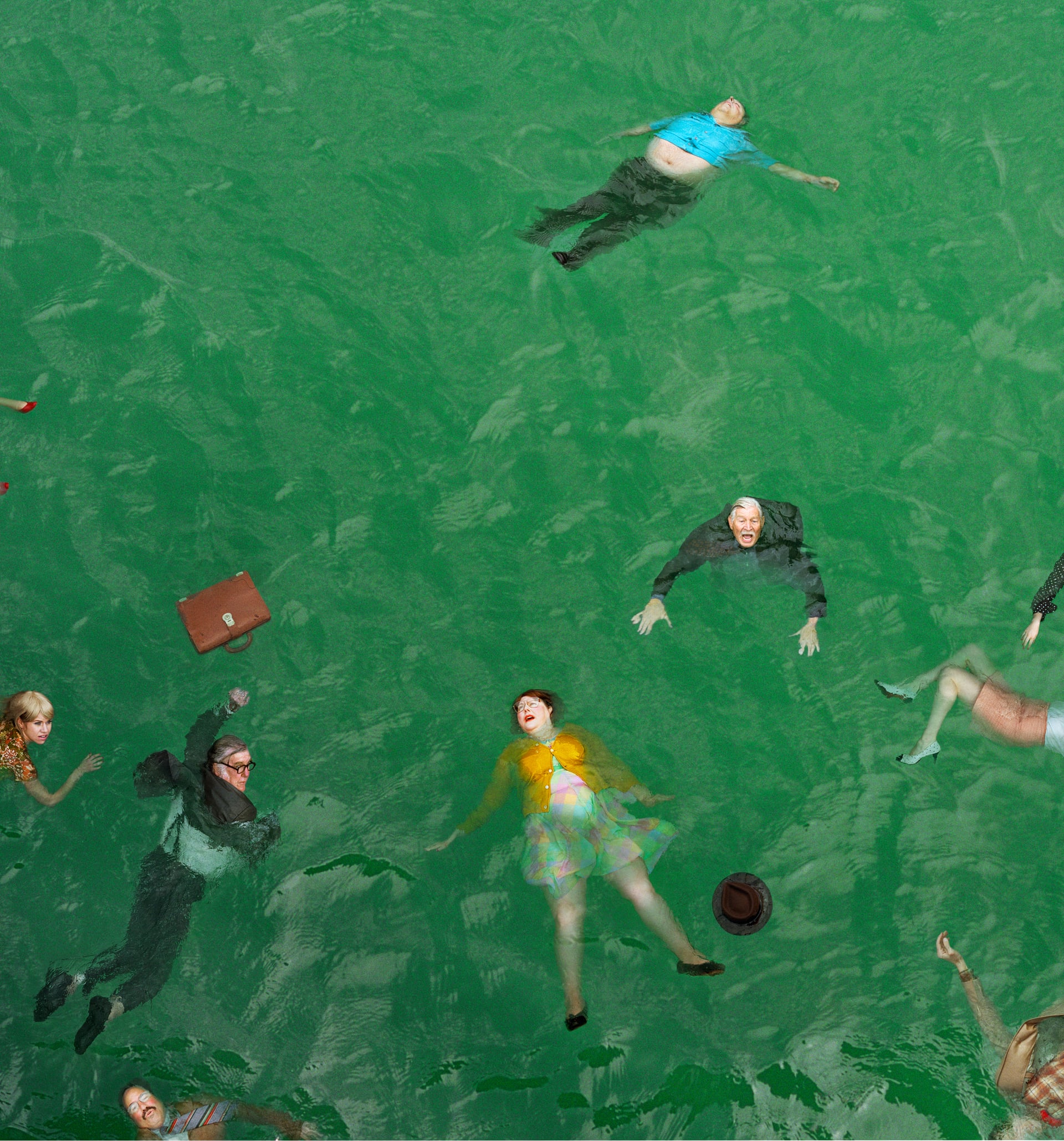 High angle shot of a group of fully dressed people floating in green water like they might have been in a plane crash